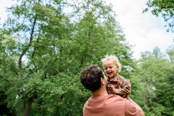 Portrait of dad hugging little son, enjoying time together. Fathers day concept.