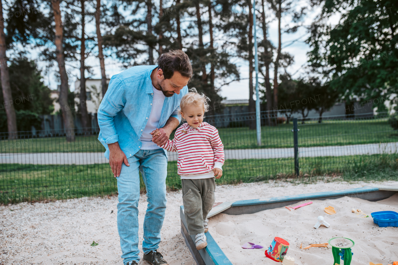 Portrait of dad and child enjoying time together on the playground. Fathers day concept.