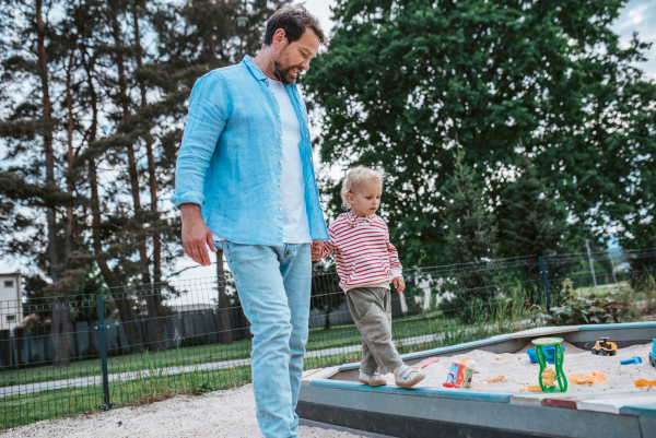 Portrait of dad and child enjoying time together on the playground. Fathers day concept.