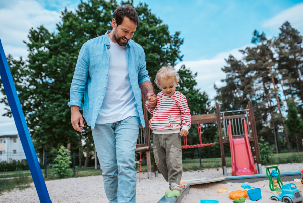 Portrait of dad and child enjoying time together on the playground. Fathers day concept.