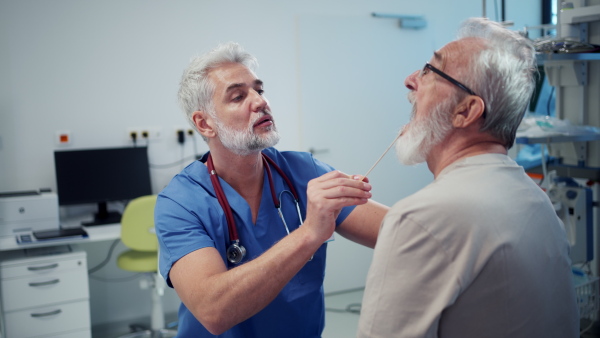 Medical professional examining patient sitting in examination room. Emergency room setting.