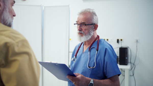 Patient sitting on examination table, talking with doctor about symptoms and his health problems.
