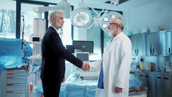 Video of pharmaceutical sales representative shaking hand with doctor. Hospital director, manager of private medical clinic.