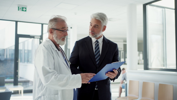 Doctor talking with pharmaceutical representative, hospital setting.