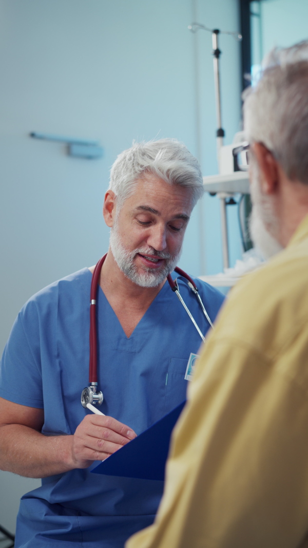 Patient sitting on examination table, talking with doctor about symptoms and his health problems.
