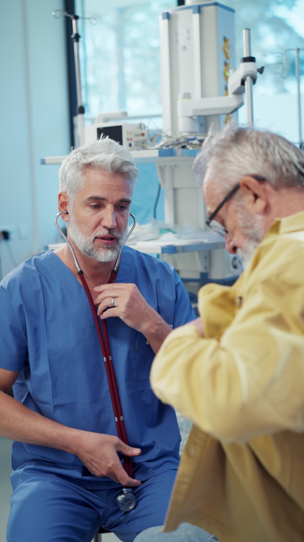 Doctor examining sick patient, listening to breathing with stethoscope.