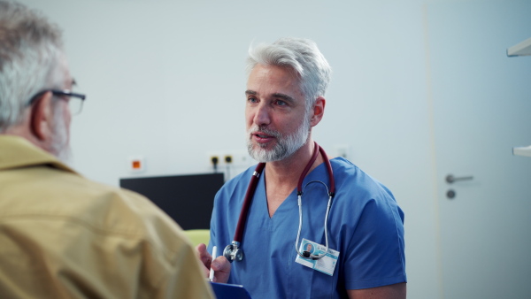 Patient sitting on examination table, talking with doctor about symptoms and his health problems.
