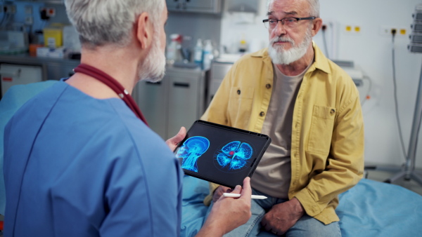 Patient sitting on examination table, describing health problems.