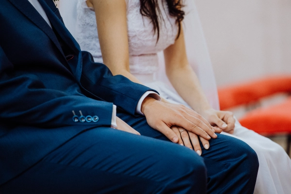 Wedding couple holding hands.