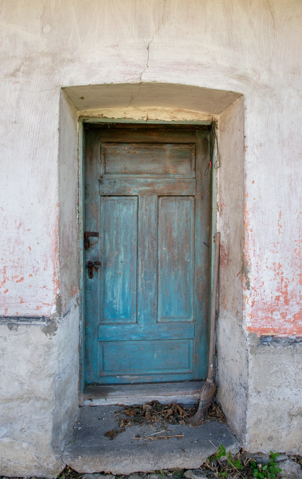 Weathered Blue Door of Rural House